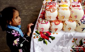 A girl admires the sugar skulls, Patzcuaro, Michoacan.