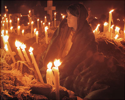 Woman with a somber gaze in the cemetery vigil